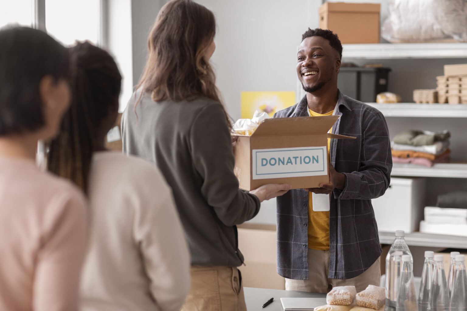 volunteer-collecting-donation-box-from-another-volunteer